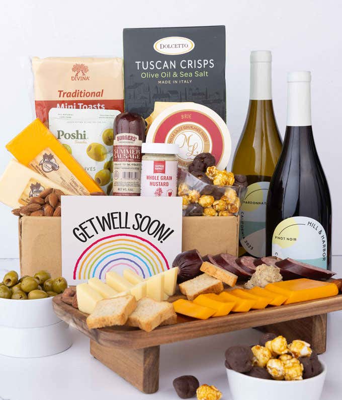 An abundant gift box filled with California Pinot Noir and Chardonnay, assorted crackers, three cheeses, summer sausage, and snacks with a Get Well Card. 