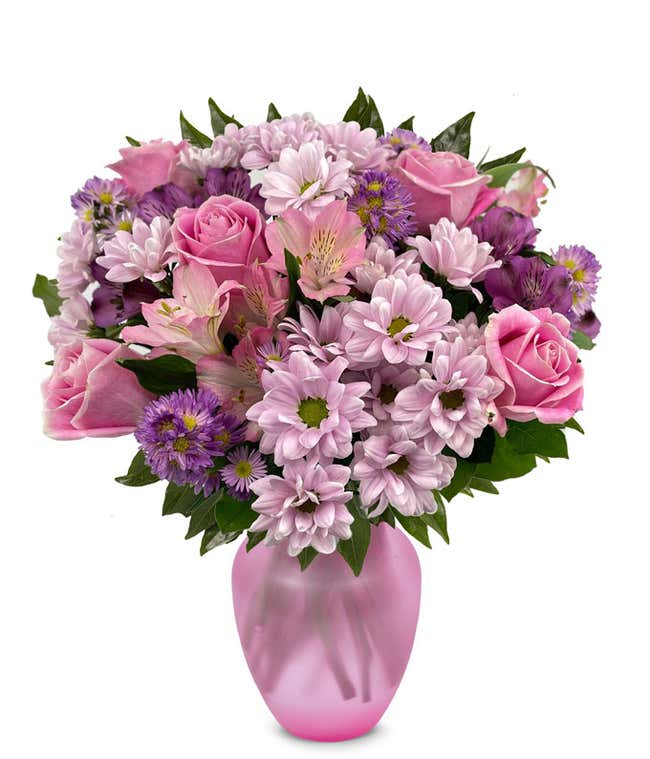 A vibrant arrangement featuring pink roses, purple daisies, pink alstroemeria, purple alstroemeria, and purple Monte Casino, optionally arranged in a vase. This colorful mix offers a cheerful and lively display.