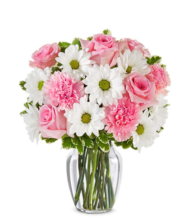 Floral arrangement featuring pink roses, white daisies, and pink carnations, optionally in a vase.
