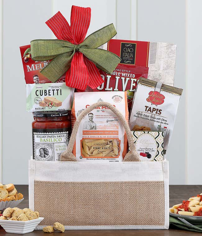 Gift basket with Italian gourmet treats and a green bow.