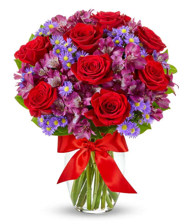 Red roses arranged with purple alstroemeria and monte casino.