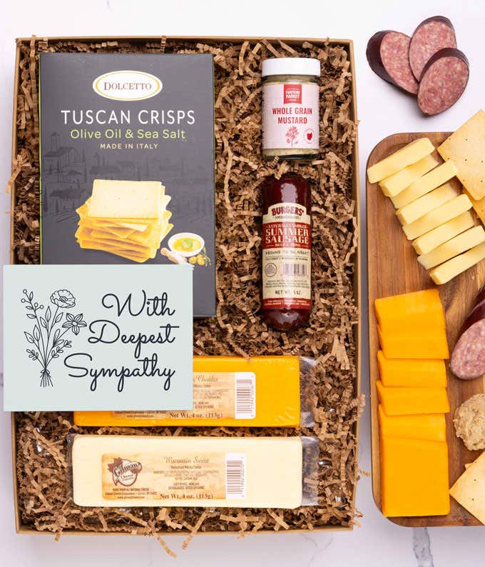 A charcuterie box with two types of cheese, crackers, stone-ground mustard, a summer sausage and a heartfelt 'With Sympathy' message card.