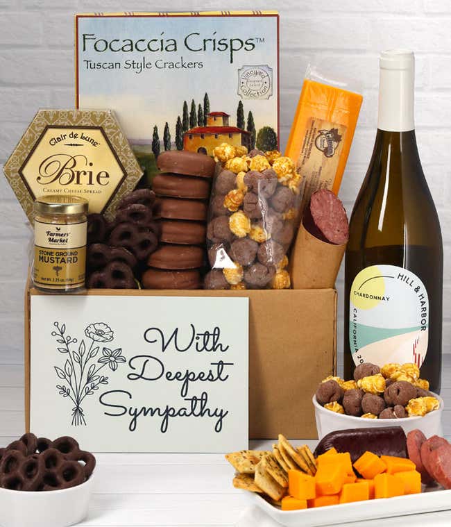 A gift set with a bottle of California Chardonnay, focaccia crisps, two cheeses, mustard, summer sausage, caramel popcorn, chocolate pretzels, six chocolate-covered Oreos and a Sympathy card to show your support.