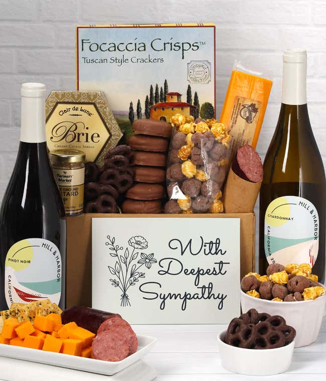 A gift set featuring two bottles of Hill &amp; Harbor wine - white and red, focaccia crisps, two cheeses, mustard, summer sausage, caramel popcorn, chocolate pretzels, six chocolate-covered Oreos and a Sympathy card to show your support.