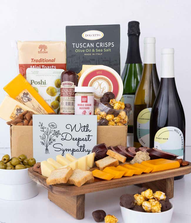 A wine and cheese gift set featuring 3 bottles of Hill &amp; Harbor wine - red, white and sparkling. Includes a variety of gourmet cheeses, crackers, olives, almonds, sausage, and condiments finished with a Sympathy Card.