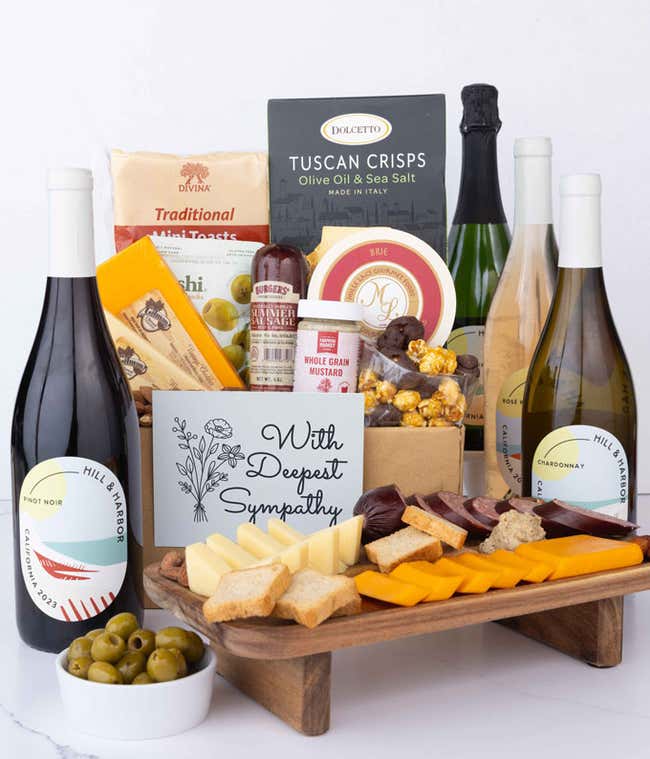 A wine and cheese gift set featuring 4 bottles of Hill &amp; Harbor wine - red, white, ros&eacute; and sparkling. Includes a variety of gourmet cheeses, crackers, olives, almonds, sausage, and condiments finished with a Sympathy Card.